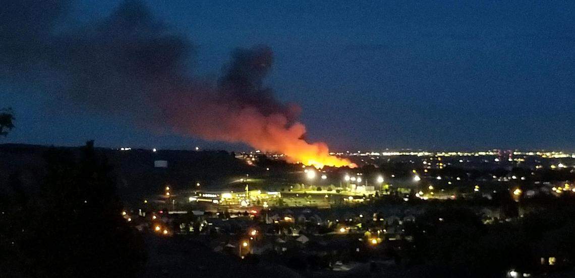 A Richland brush fire that closed Highway 240 on Wednesday continued to burn into the night.