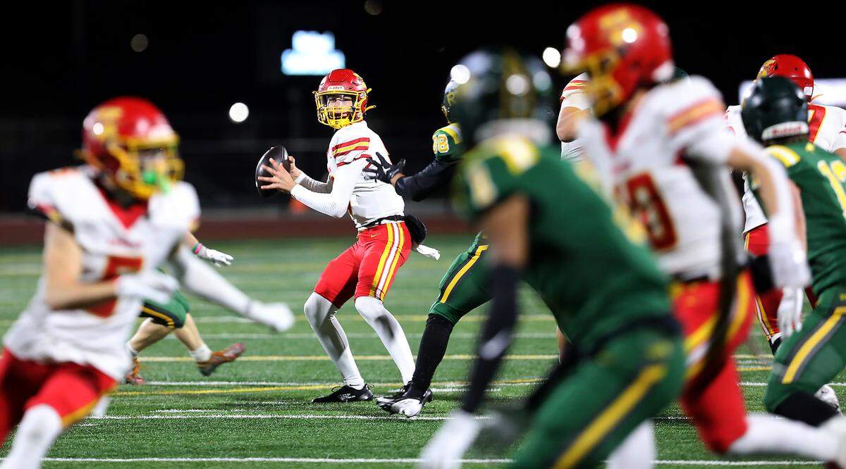 Kamiakin quarterback Jagger McEwen looks for an open receiver downfield during their game against the Bombers in Richland on Oct. 30, 2025. Richland won 15-14 to clinch 2nd seed for the playoffs.