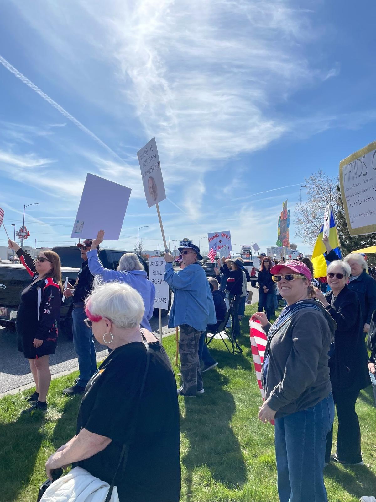 Hundreds of people lined Columbia Center Boulevard in Kennewick Saturday for a “Hands Off! Kennewick Fights Back,” to protest Trump administration policies.