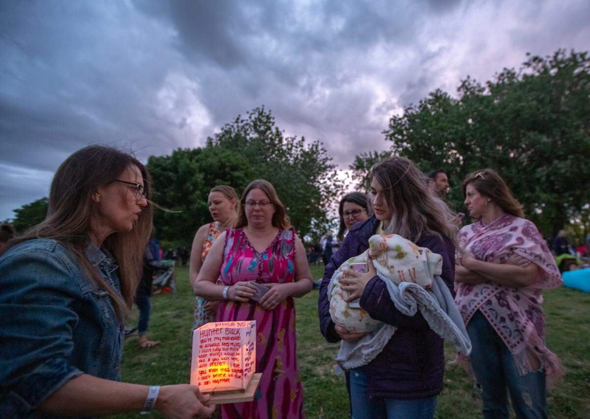 Hunter Black’s family and friends walk down to the pond to release their water lanterns in memory of him during the Water Lantern Festival at Columbia Park. The lanterns had messages and memories written about Black.