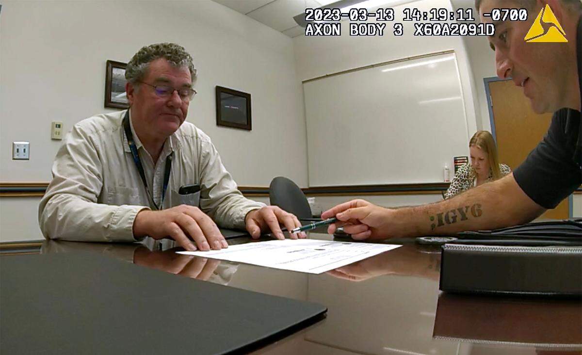 Former Kennewick Mayor Bill McKay answers questions about local massage parlors from Kennewick Detectives Elizabeth Grant, middle, and Kris Safranek during a March 13, 2023 interview at the Kennewick Police station.