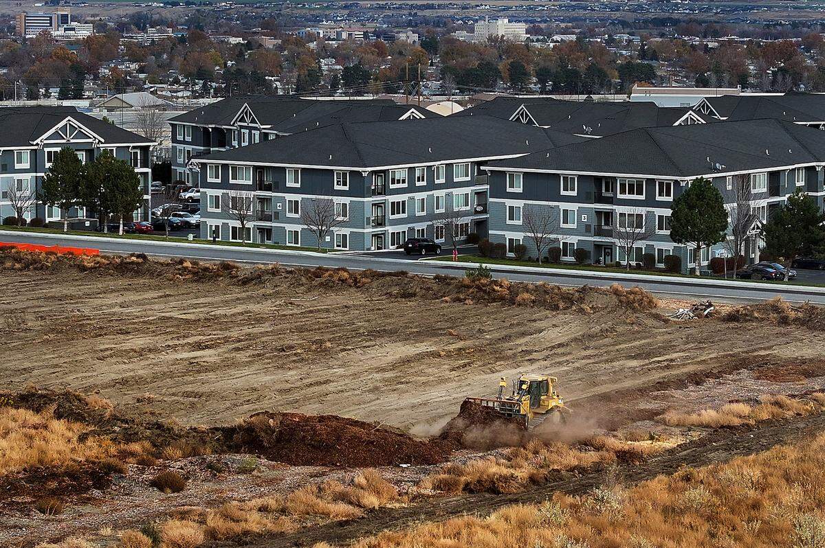 A large bulldozer levels dirt into a Costco-shaped rectangle in Richland, where the warehouse giant just broke ground on its second Tri-Cities location.