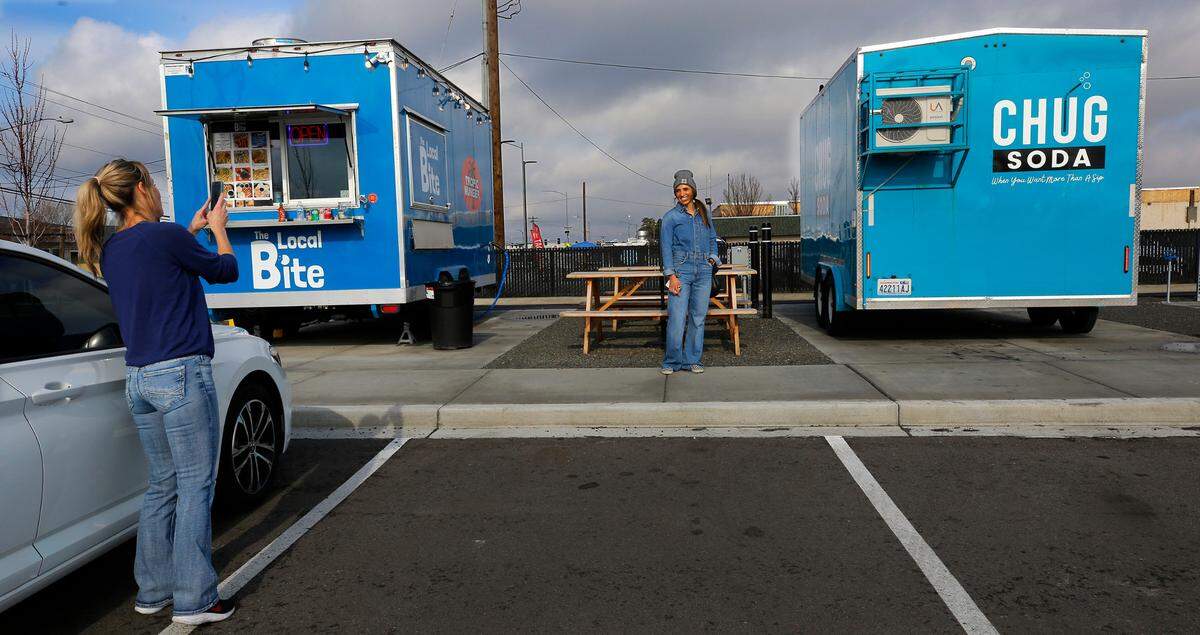 Rachel Magelsen, co-owner of Chug Soda, poses for a photo by her next-door business neighbor Rachel Lundegard while setting up her food trailer in the Edison Street Food Park in Kennewick. Lundeward’s The Local Bite and Tropic Hunger food trailer was the first one to occupy a space at the venue on West Okanogan Avenue and North Edison Street.