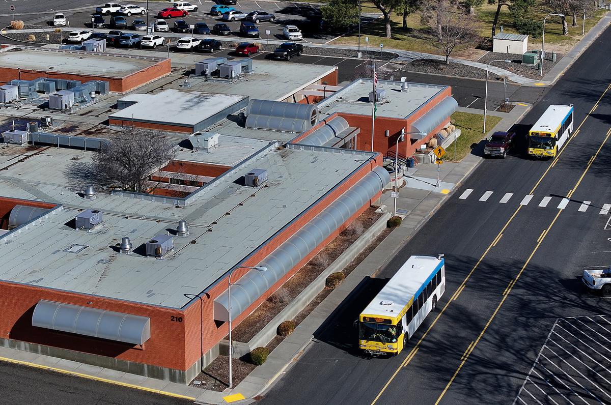 Ben Franklin Transit buses drive past the Kennewick City Hall building at 210 W. Sixth Ave. in downtown Kennewick.