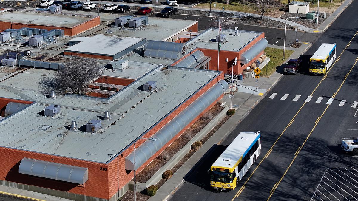 Ben Franklin Transit buses drive past the Kennewick City Hall building at 210 W. Sixth Ave. in downtown Kennewick. Taken Feb. 27, 2025.