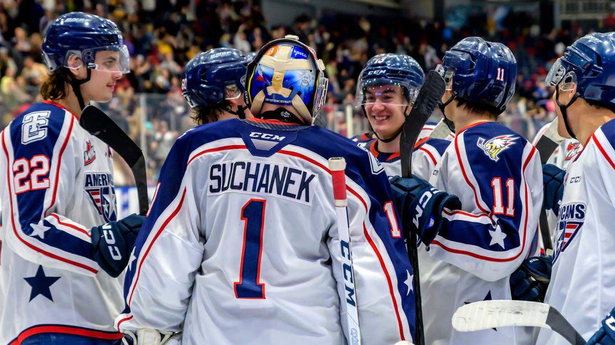 The Tri-City Americans team gathers around goaltender Tomas Suchanek during the 2022-23 season.