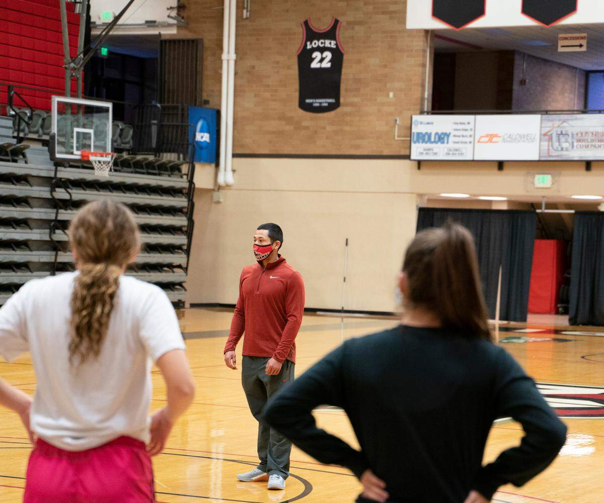 Kennewick High graduate Jarod Gonzales talks to the Northwest Nazarene University women’s basketball team during a workout earlier this month.