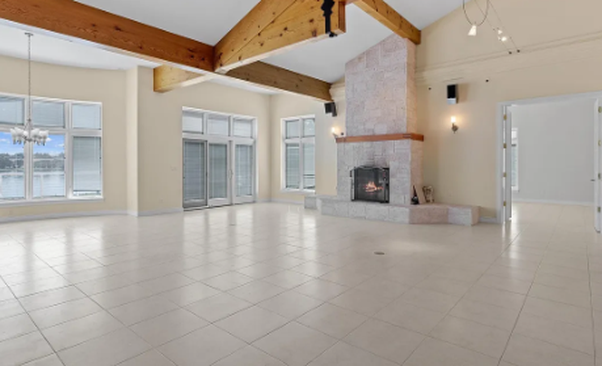 The living spaces feature exposed wood beams in the vaulted living room.