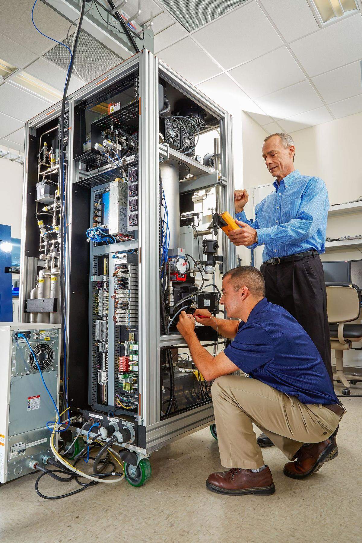The Xenon International System, a smaller, more sensitive version of the detectors used today, was developed by PNNL researchers Rey Suarez (front), Jim Hayes and their colleagues. The technology has been transferred to the private sector for production and installation at monitoring stations around the world.