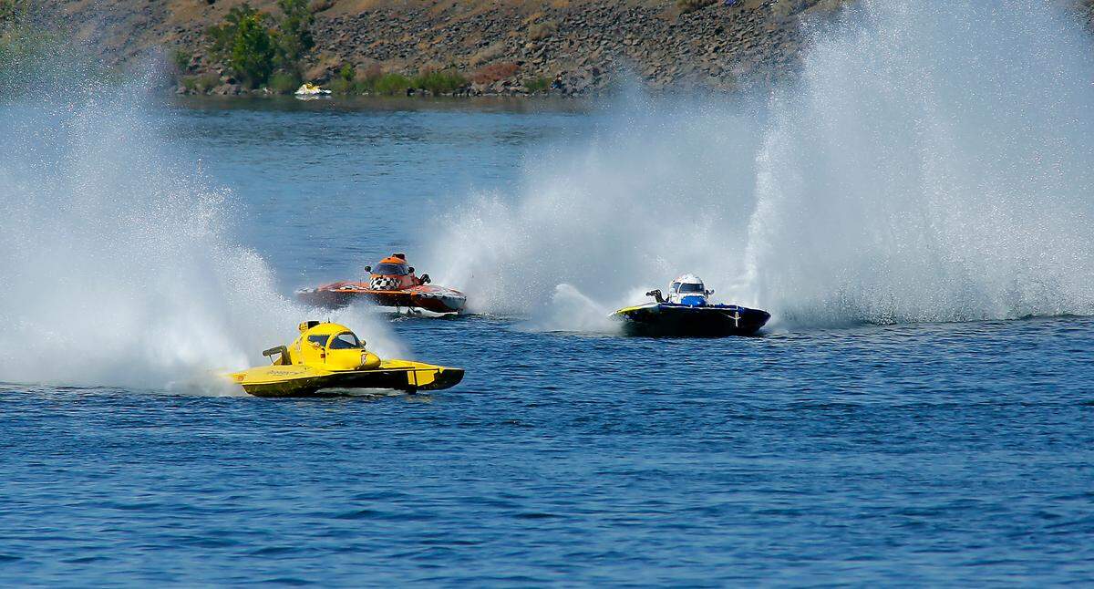 Kurt Myers in the yellow E-350 race boat races to victory in the third heat race Saturday during Columbia Cup racing action on the Columbia River.