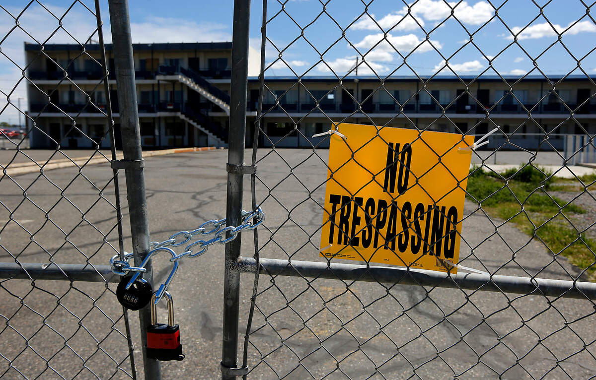 Locked chain link fencing with No Trespassing signs enclosed the Thunderbird Motel in Pasco in May 2022 before it was bought and torn down by the city.