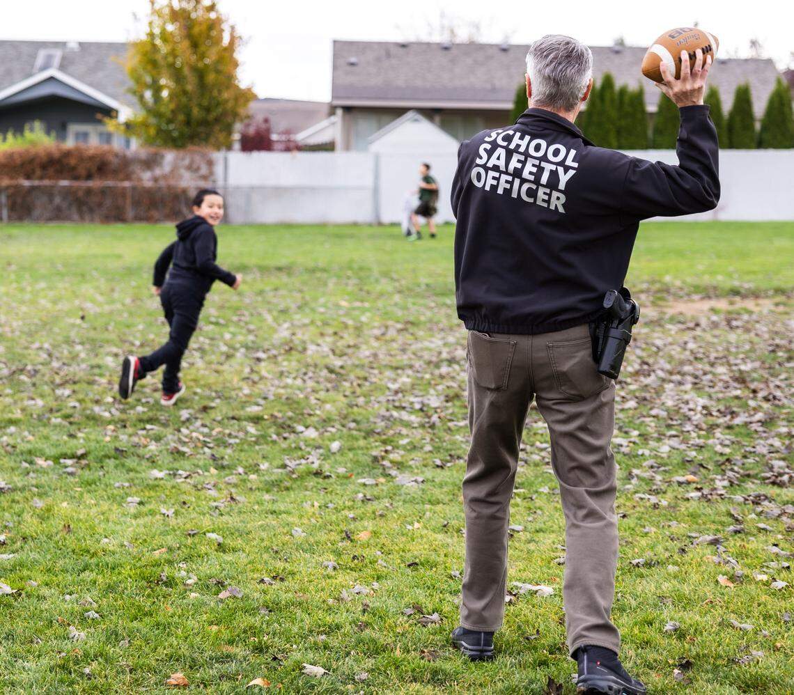 Former Benton County Sheriff Tom Croskrey tosses a ball at Lincoln Elementary School in Kennewick.