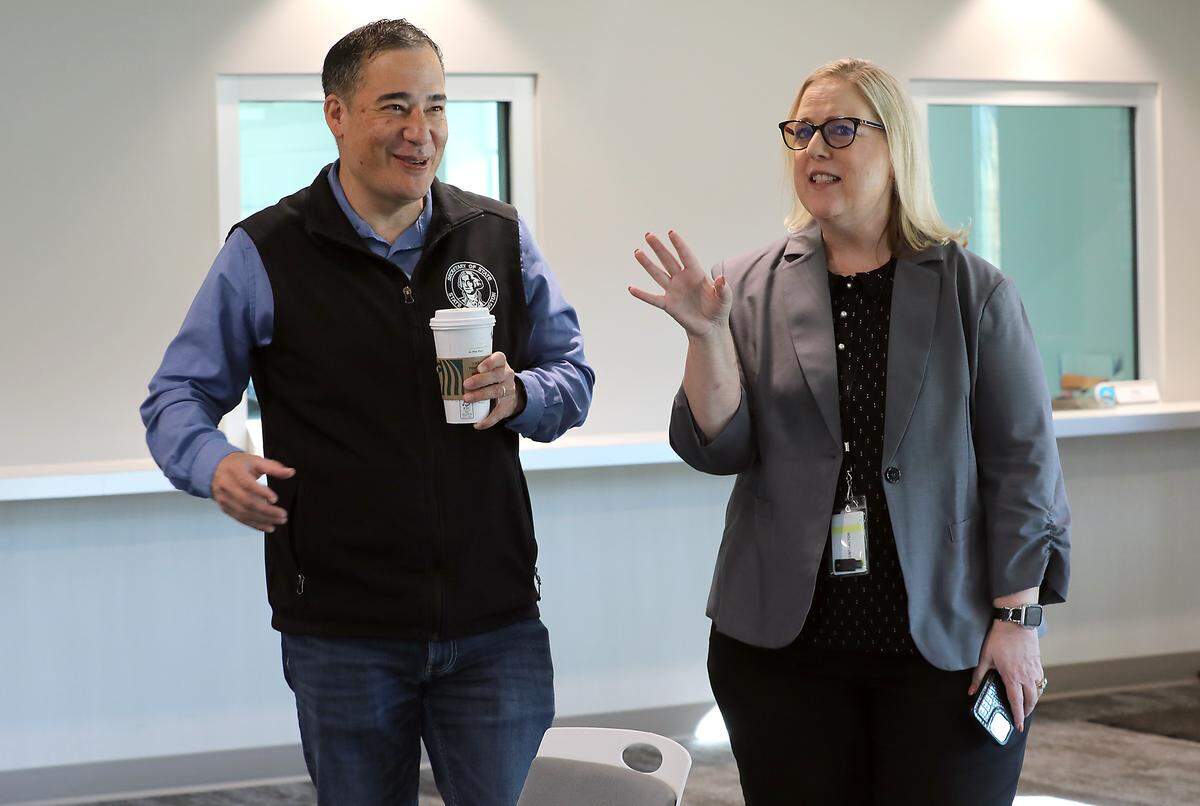 Benton County Auditor Brenda Chilton, right, talks with Washington Secretary of State Steve Hobbs Thursday morning during a tour of the Benton County Elections Center in Kennewick.