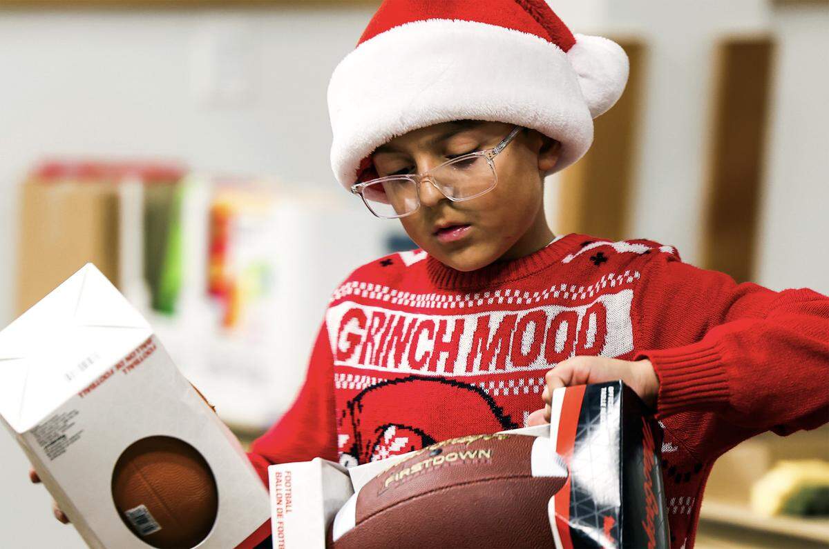 Tayden Chavez and his mom, Jennifer Chavez of Kennewick help sort, organize, select and bag up the toys for the families that will get them for Christmas through the Marine Corps Reserve Toys for Tots Santa’s Workshop.