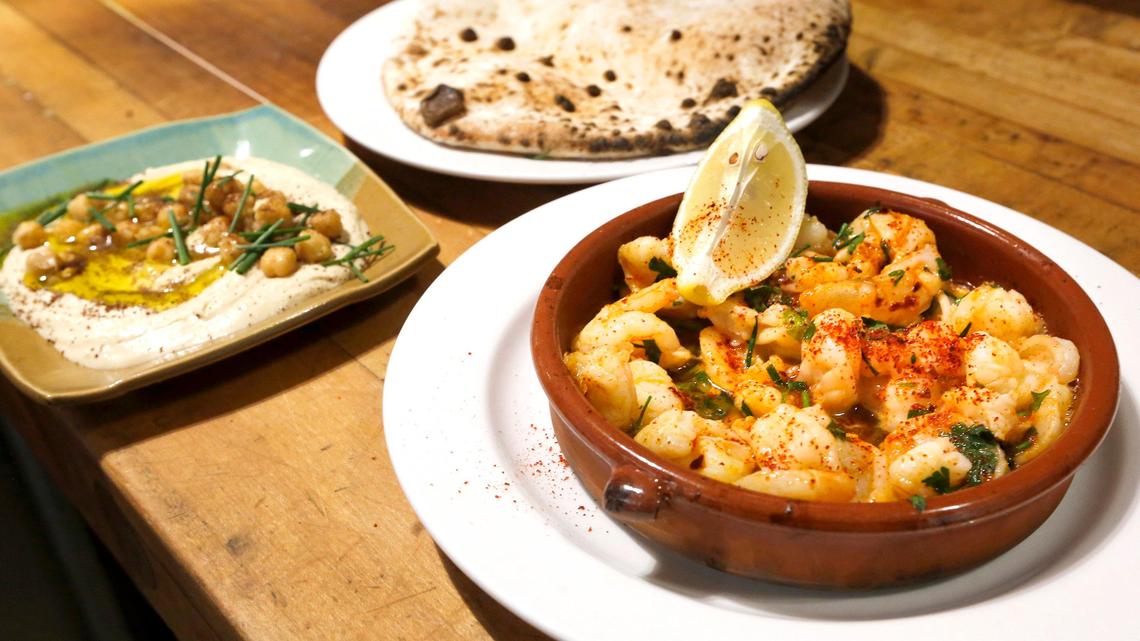 Fresh baked pita bread, hummus and shrimp pil pil, a spanish-style scampi dish, are some of the menu items offered at the Dovetail Joint restaurant at the Uptown Shopping Center in Richland. Watch a video at: tricityherald.com/videos