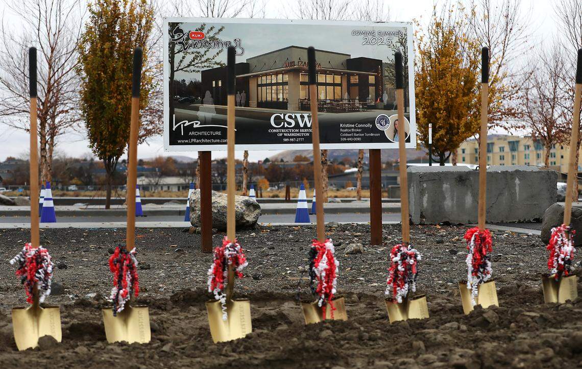 Painted shovels lined up in the dirt for the groundbreaking ceremony at Vista Field in Kennewick for the new KUKI Izakaya Restaurant.