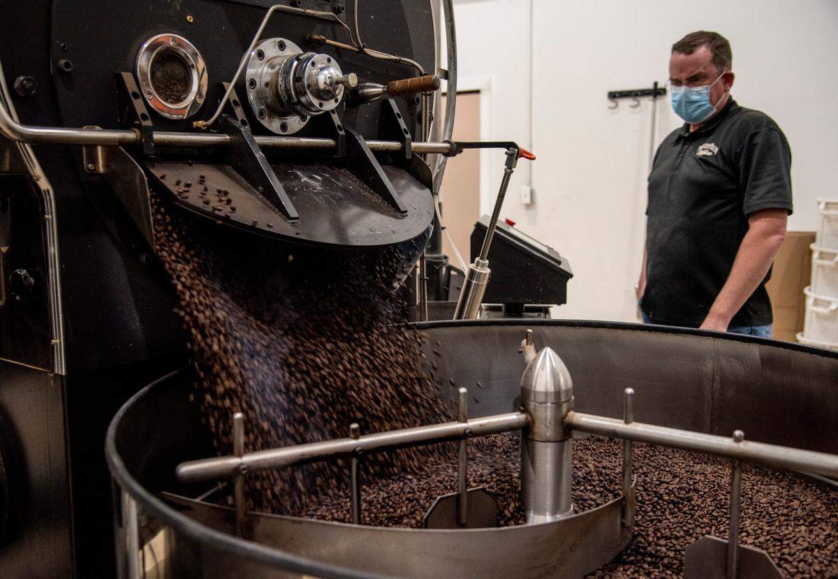 Paul Roskelley inspects a medium roast batch of beans for the Treasure Valley Coffee Company.
