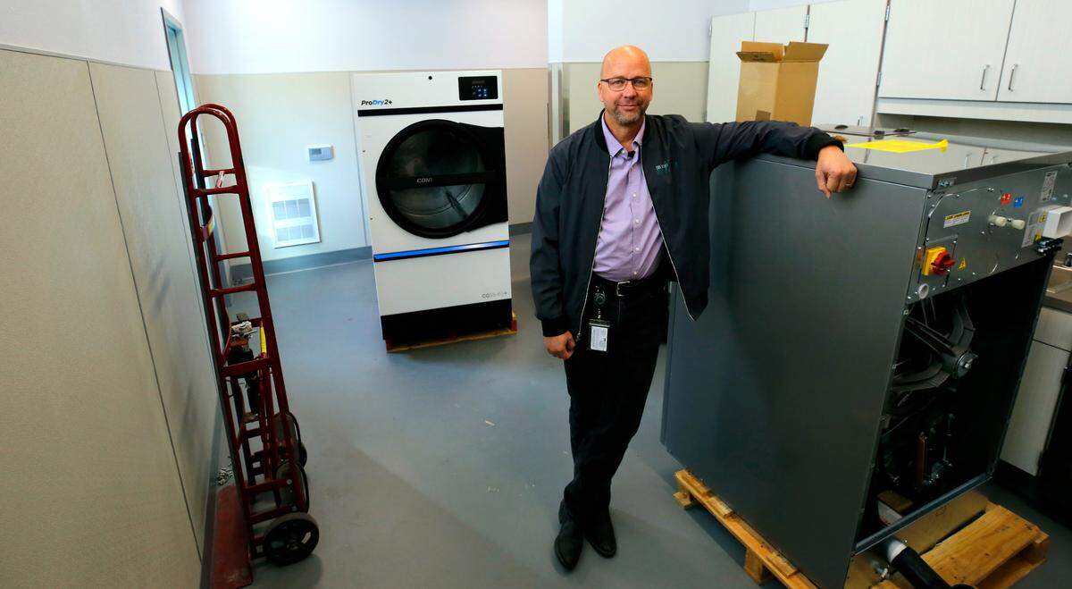 Ben Zigan, Tri-Cities Animal Shelter manager, stands next to new commercial washers and dryers that are readly for installaion into the new shelter building in Pasco.