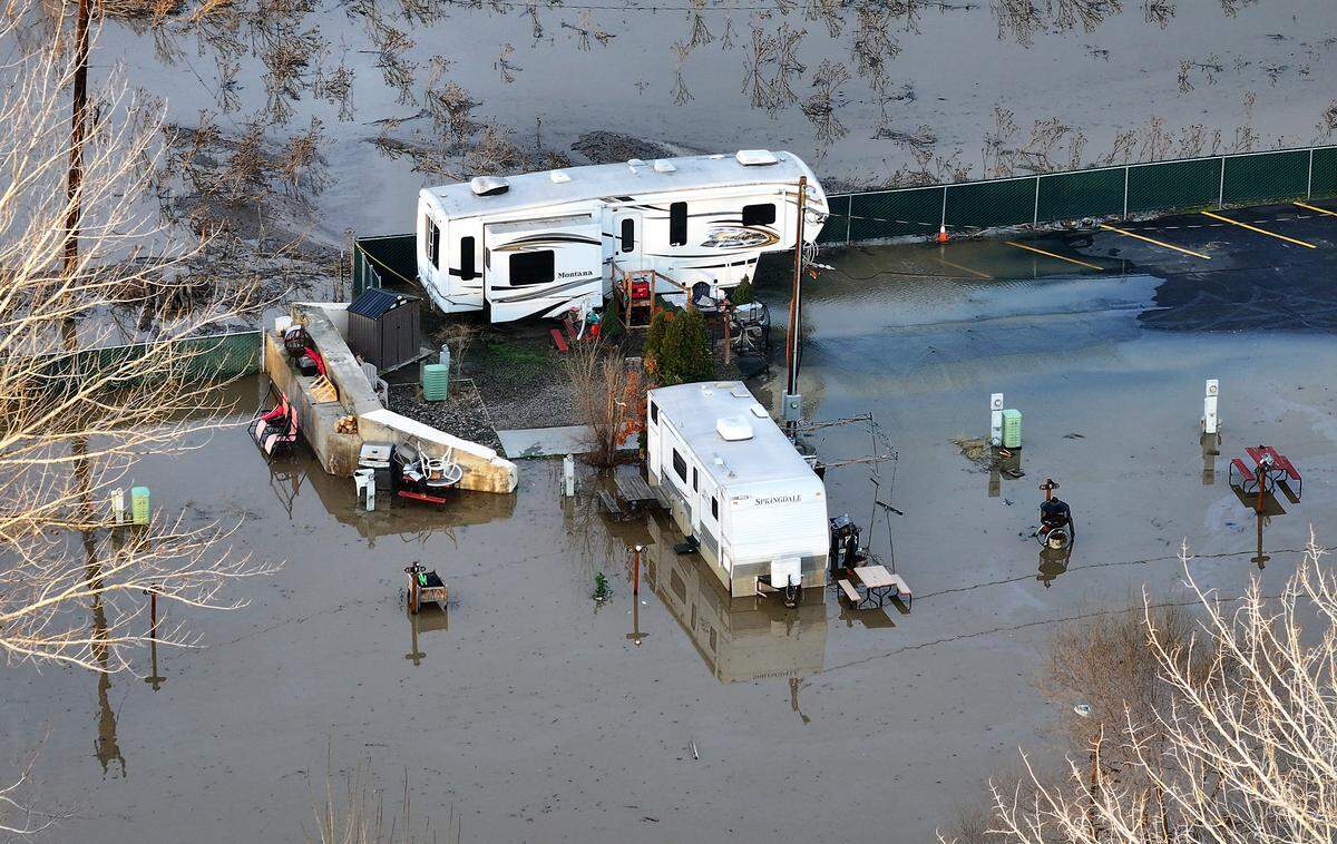 The swollen Yakima River has overflowed its banks and is flooding the Beach RV Park on Benton City. Many of the residents have moved their trailer to higher ground before the river's expected crest.