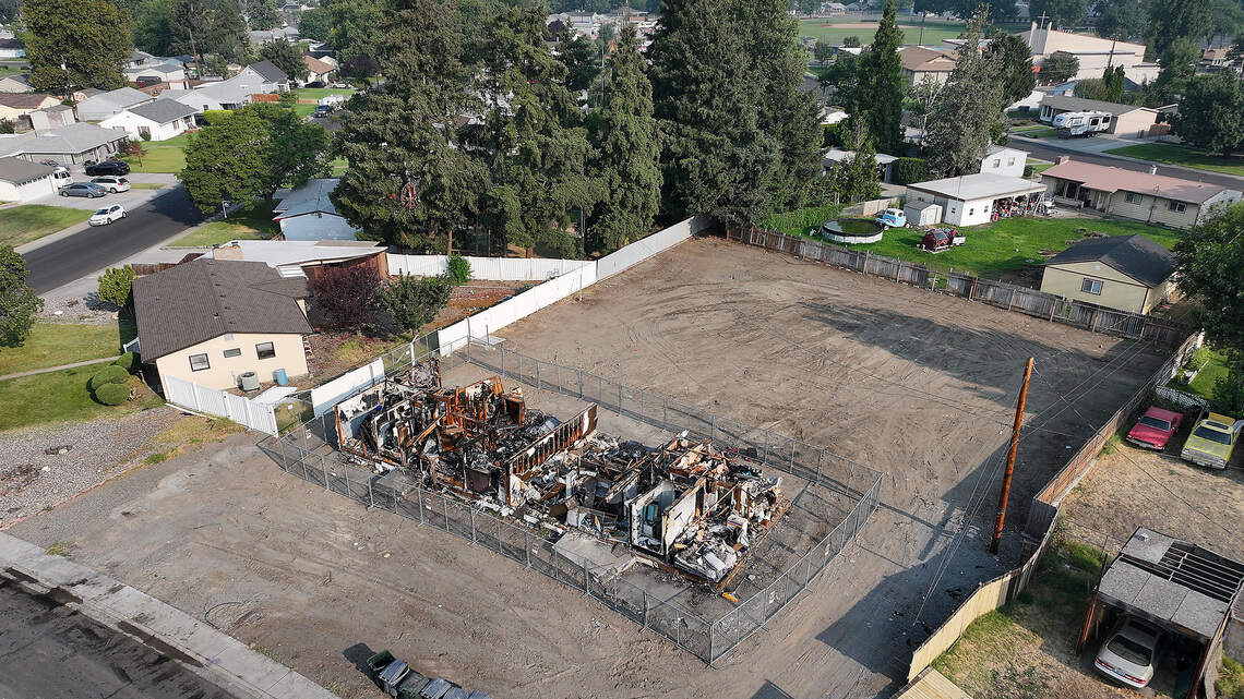 Junk-filled yard cleared. So why is a fire-gutted Richland home still standing?