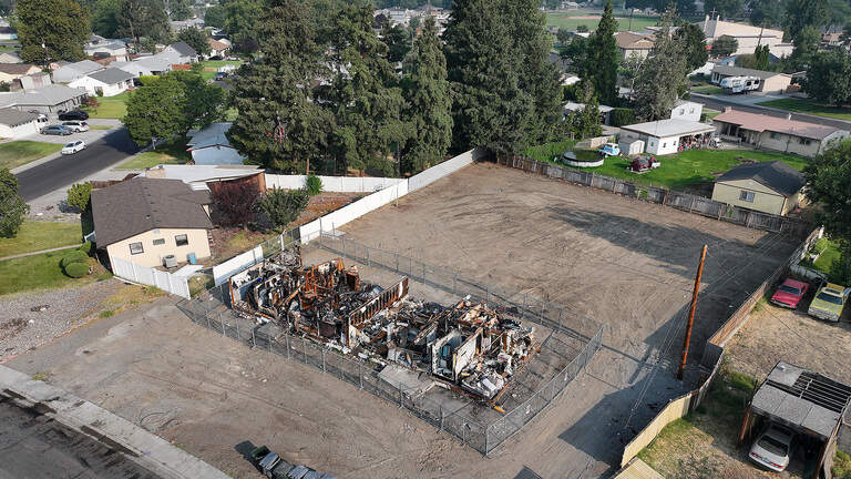 Junk-filled yard cleared. So why is a fire-gutted Richland home still standing?