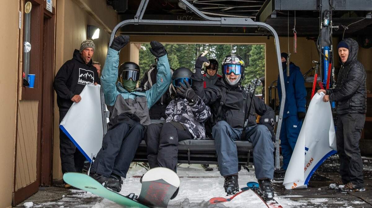 Skiiers break through an opening day banner at Bluewood Ski Area in Dayton.