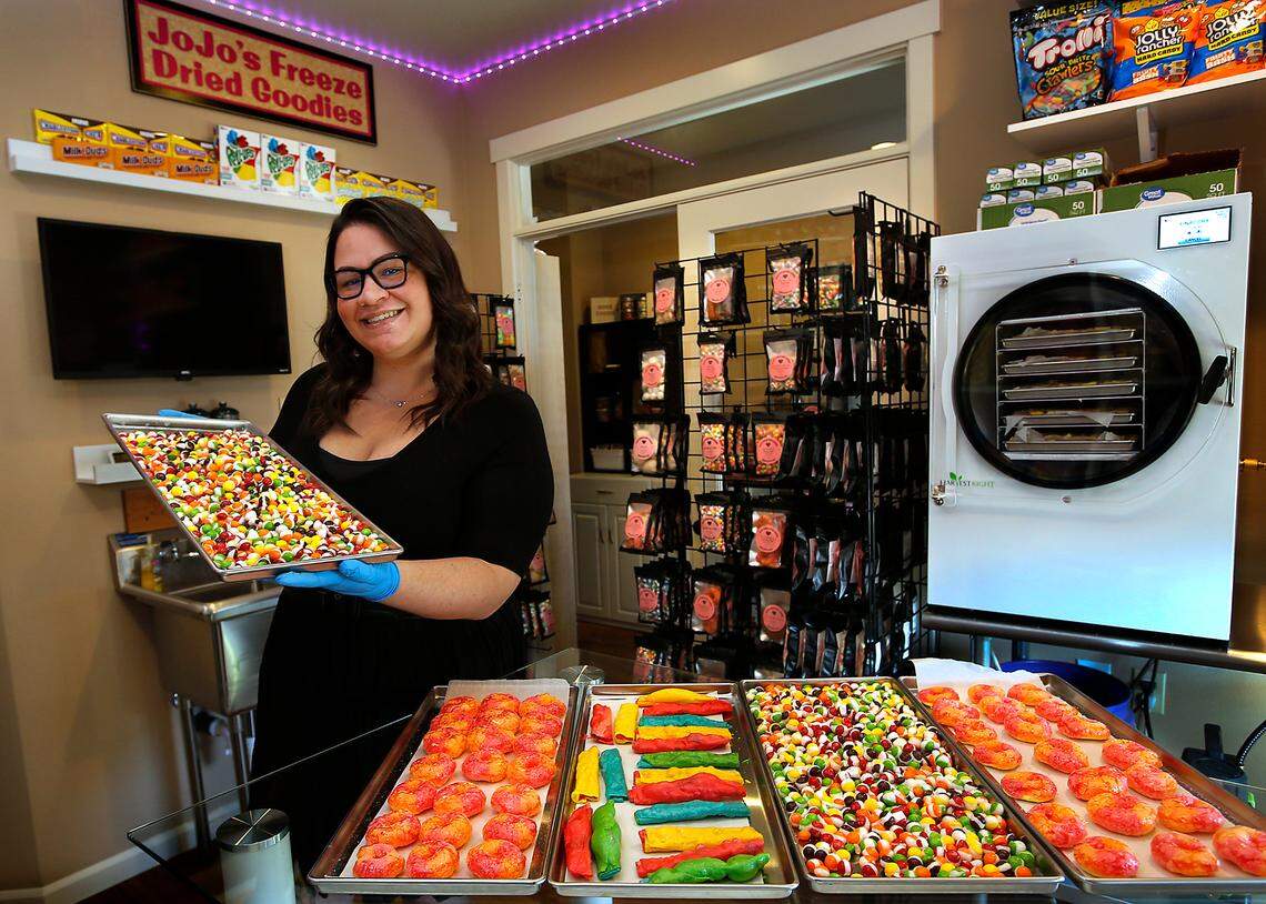 Sarra Hendrick, owner of JoJo’s Freeze Dried Goodies, holds a tray of finished candy that spent about 96 hours in a freeze drier in the licensed commercial kitchen she installed in her Pasco home.