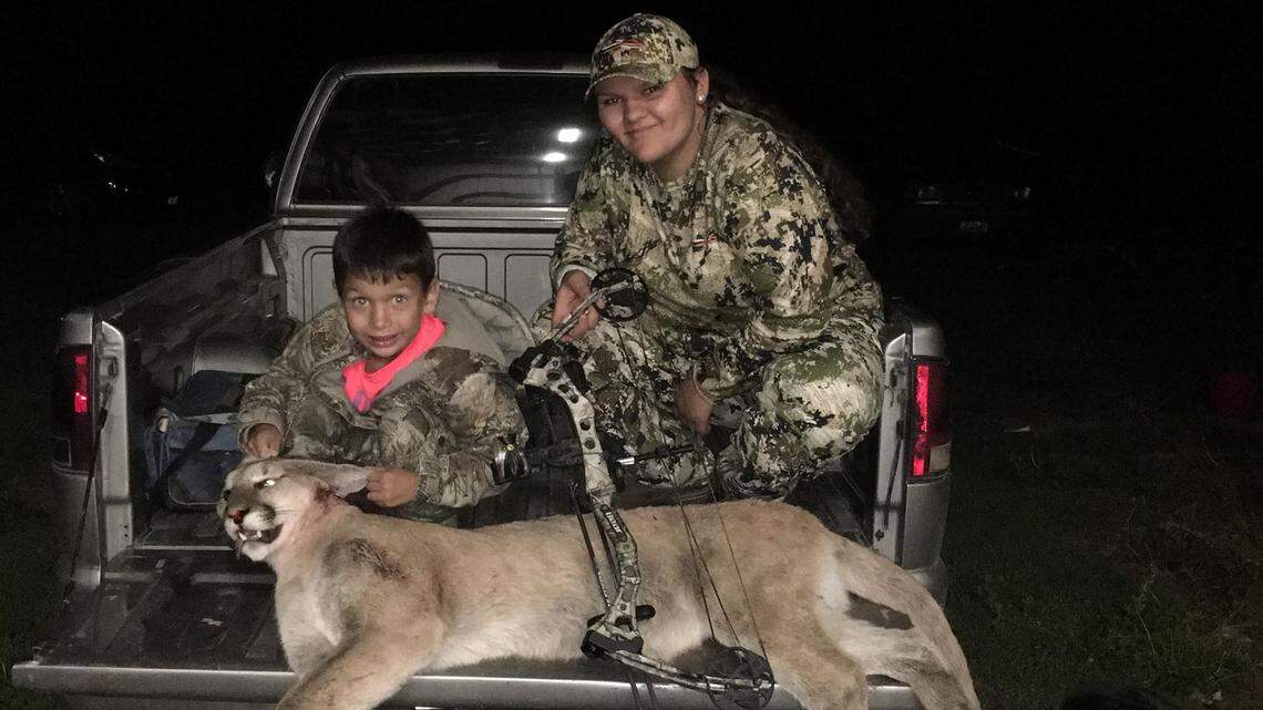 Amaya Simpson and her brother Cole Seymour pose with the cougar Amaya says she shot with her bow and arrow after it threatened Cole near their home on the Colville Indian Reservation in Washington.