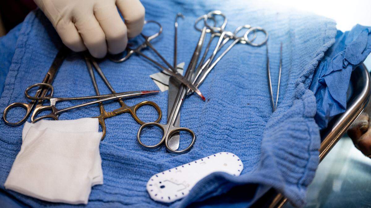 HOUSTON, TEXAS - JULY 18: A veterinarian reaches for tools during surgery on a dog at the Harris County Pets animal shelter on July 18, 2022 in Houston, Texas. The shelter has reported being over-capacity and under staffed as a steady increase of animal returns and rescues overwhelms the facility. "This facility comfortably holds approximately 250-275 dogs, but as of this morning we had about 380 dogs in here...We have limited staffing resources and we want to maintain humane conditions, so that's why its important for us to find a positive outcome for this overcrowding," says Education and Outreach Manager Shannon Parker. Animal shelters around the country are seeing an influx of returned pets, and shelters are reporting being over-capacity and under-staffed due to factors including rescues, fewer adoptions and people returning to work as the COVID-19 pandemic subsides. (Photo by Brandon Bell/Getty Images)