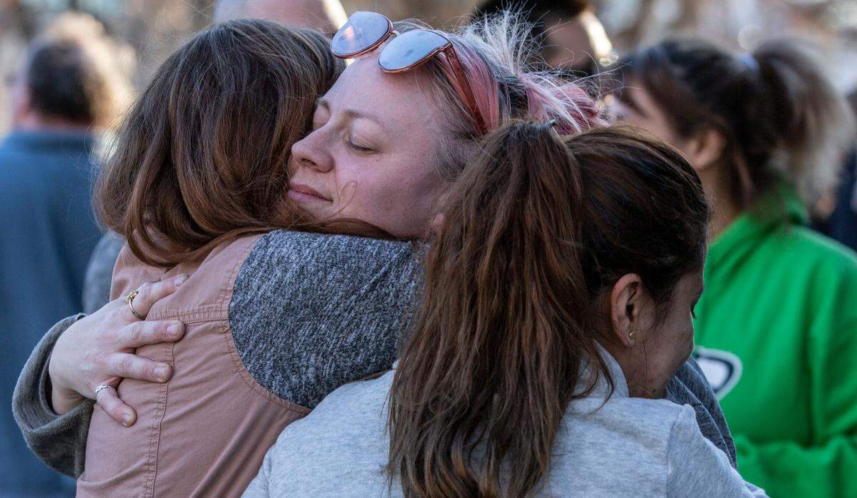Memorial attendees give Krista Krumbah, Justin Krumbah’s older sister, hugs after gathering in Howard Amon Park in Richland on Thursday to celebrate her brother’s life.