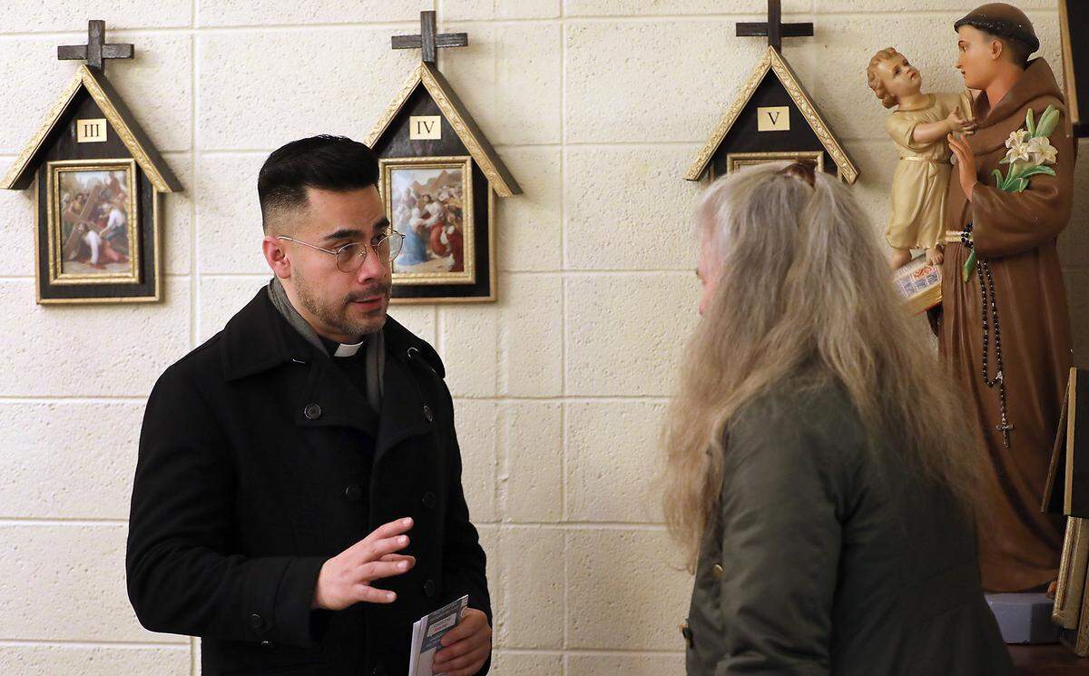 Rev. Cesar Izquierdo talks with parishioner Cyle Nielsen following a recent morning mass held in the chapel of the St. Rose of Lima Catholic Church in Ephrata.