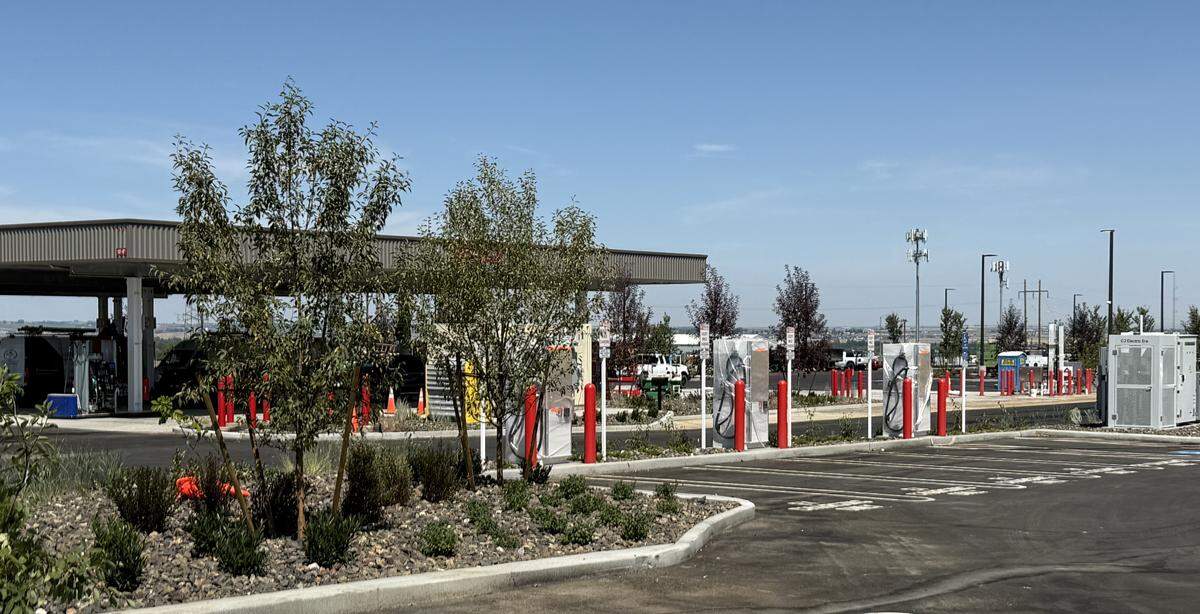 Electric vehicle charging stations stand at the ready near the fueling station at Costco on Queensgate.