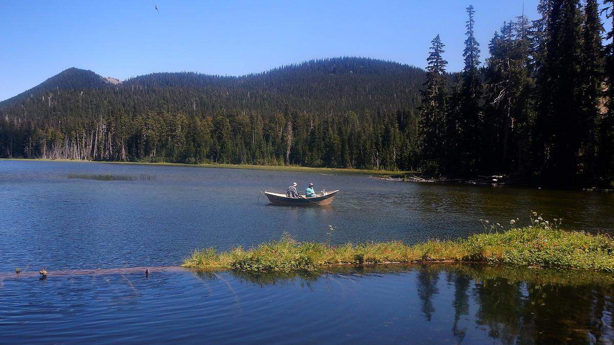 Two fly casters ply their luck from a drift boat at the upper end of Leech Lake near White Pass.