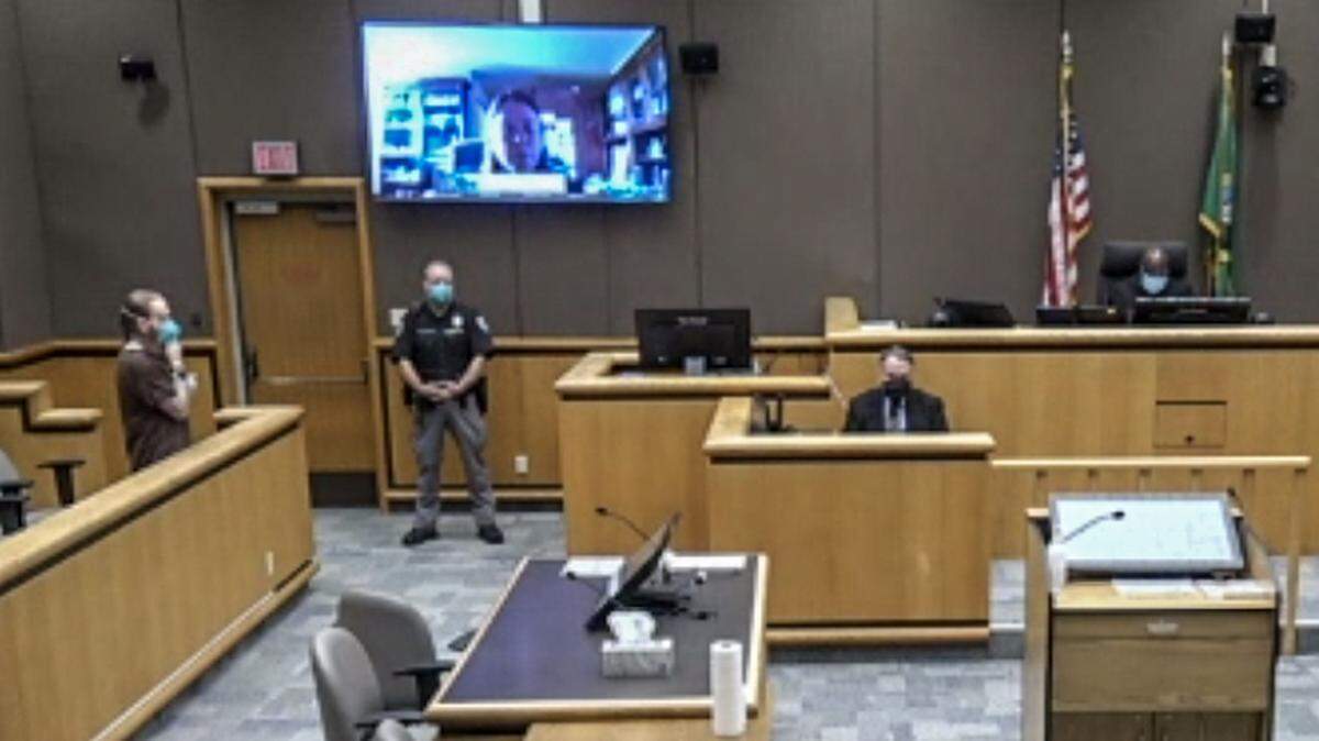 Michael G. Cook, in the jury box on the far left, appeared Wednesday before Judge Cameron Mitchell to plead guilty to rendering criminal assistance in the September 2020 shooting death of Joshua R. Gibson. Defense attorney Shelley Ajax is on the large TV screen in Benton County Superior Court.