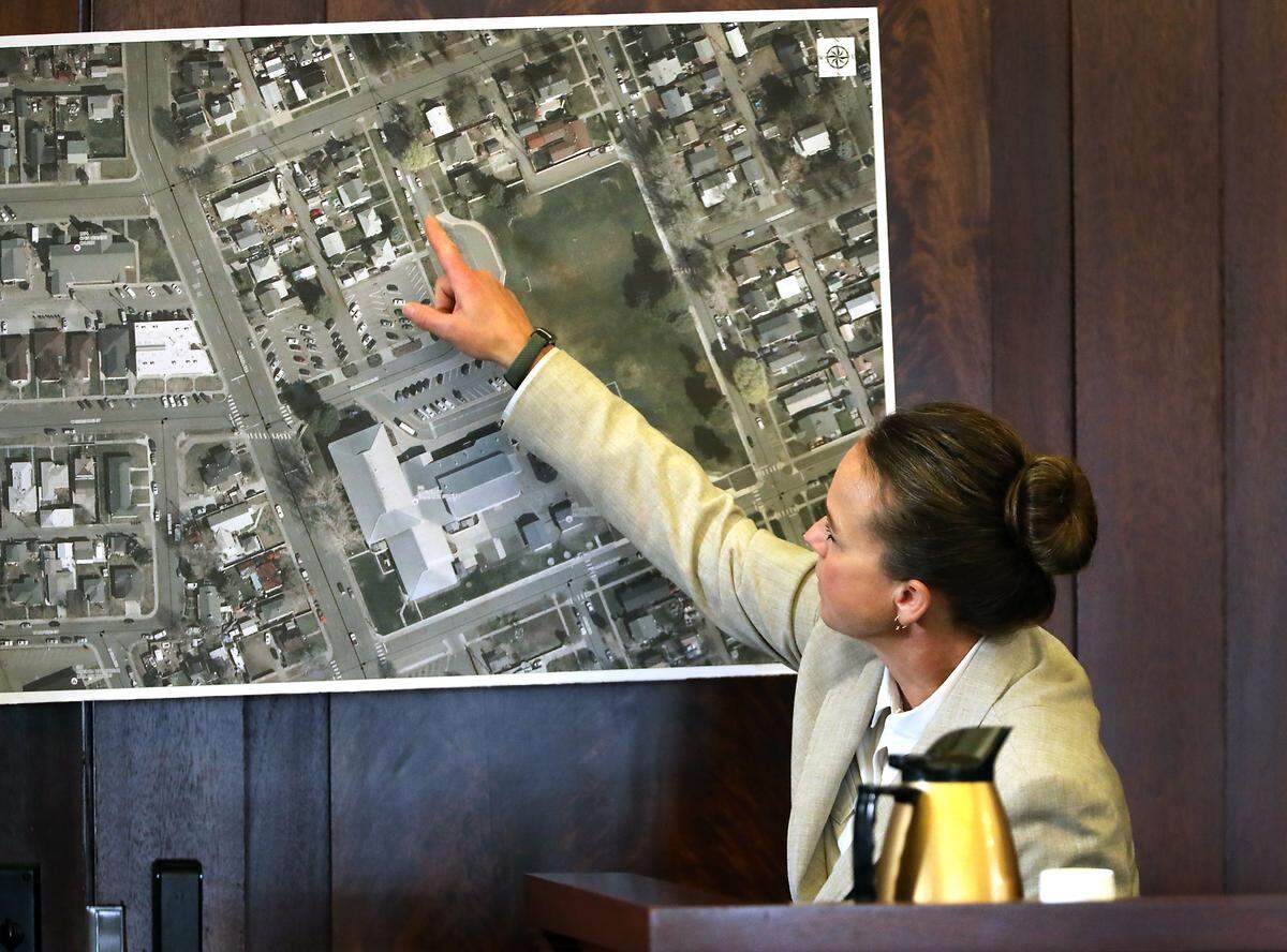 Pasco Detective Julie Lee points to a poster sized aerial photograph of the area around Longfellow Elementary School in Pasco while giving her testimony.