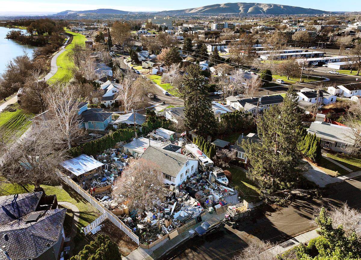 The junk and debris-covered yard is at 1312 Hains Ave. in Richland.