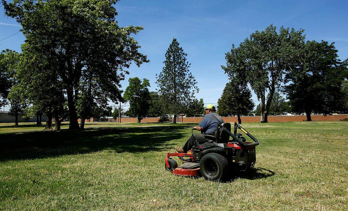 A Port of Kennewick employee mows the grass Friday at the 6.5-acre site of the former Willows Trailer Court near Clover Island in downtown Kennewick. Members of the public have been outspoken after the Port of Kennewick began discussions about housing for low-income individuals and families on the land the port owns at Columbia Drive and Clover Island Drive.