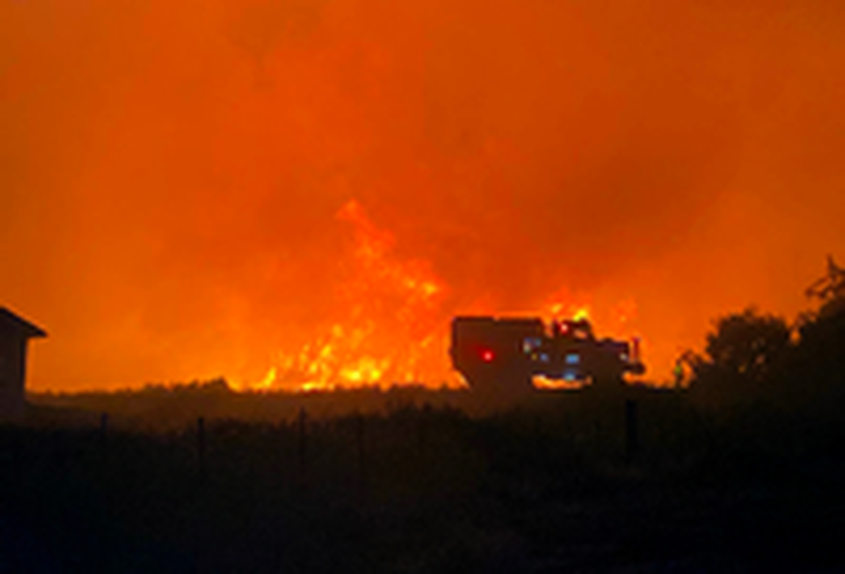 Fire crews battle a large brush fire that threatened houses in the area of Northlake Drive and Clark Court on West Richland
