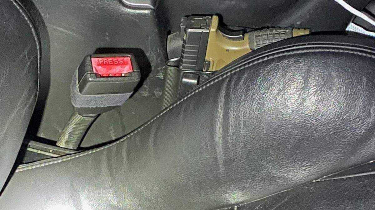 A gun was tucked into the passenger side of a car that was left in a road after deputies spotted it going 130 mph.
