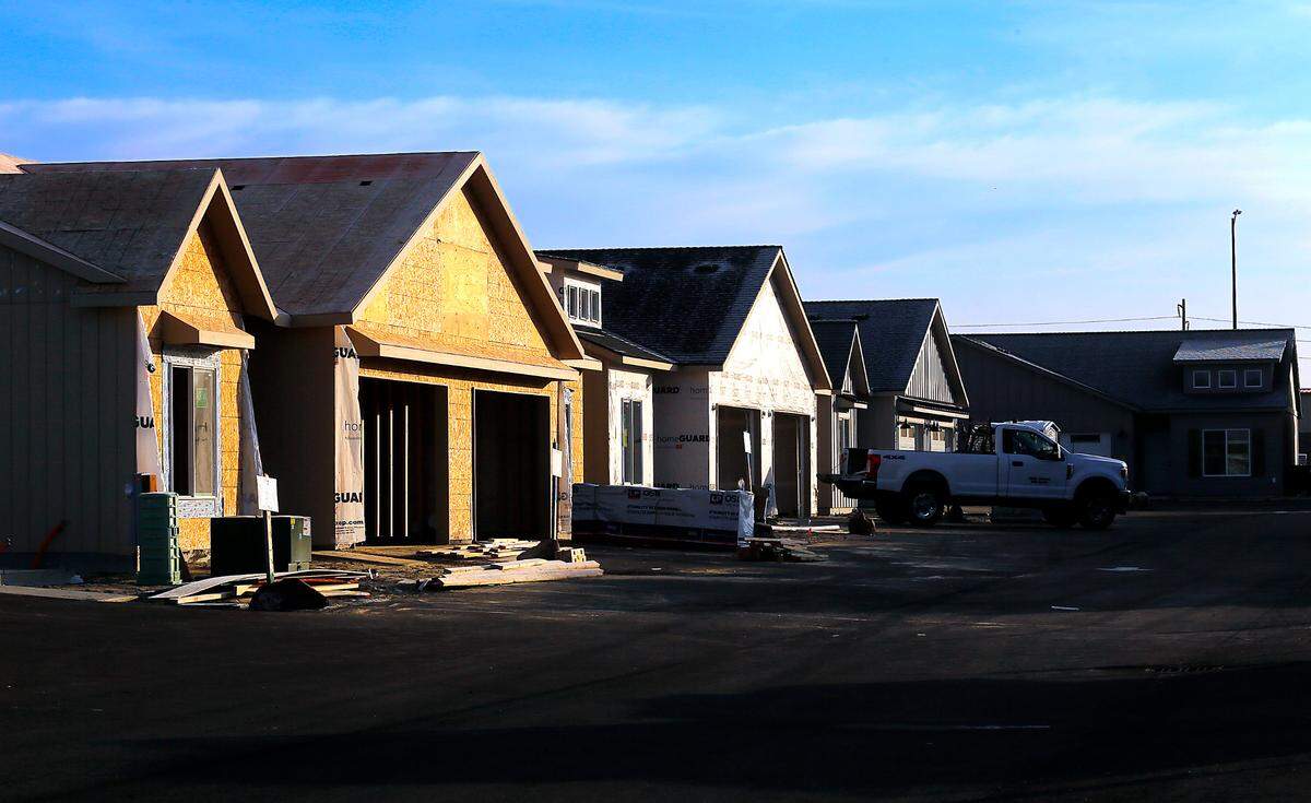 Work continues on some of the units at the partially completed 84-unit duplex project by Big Sky Developers called Sandy Flats in west Pasco. Lawmakers in Olympia are working together this year on bills aimed at easing housing woes.
