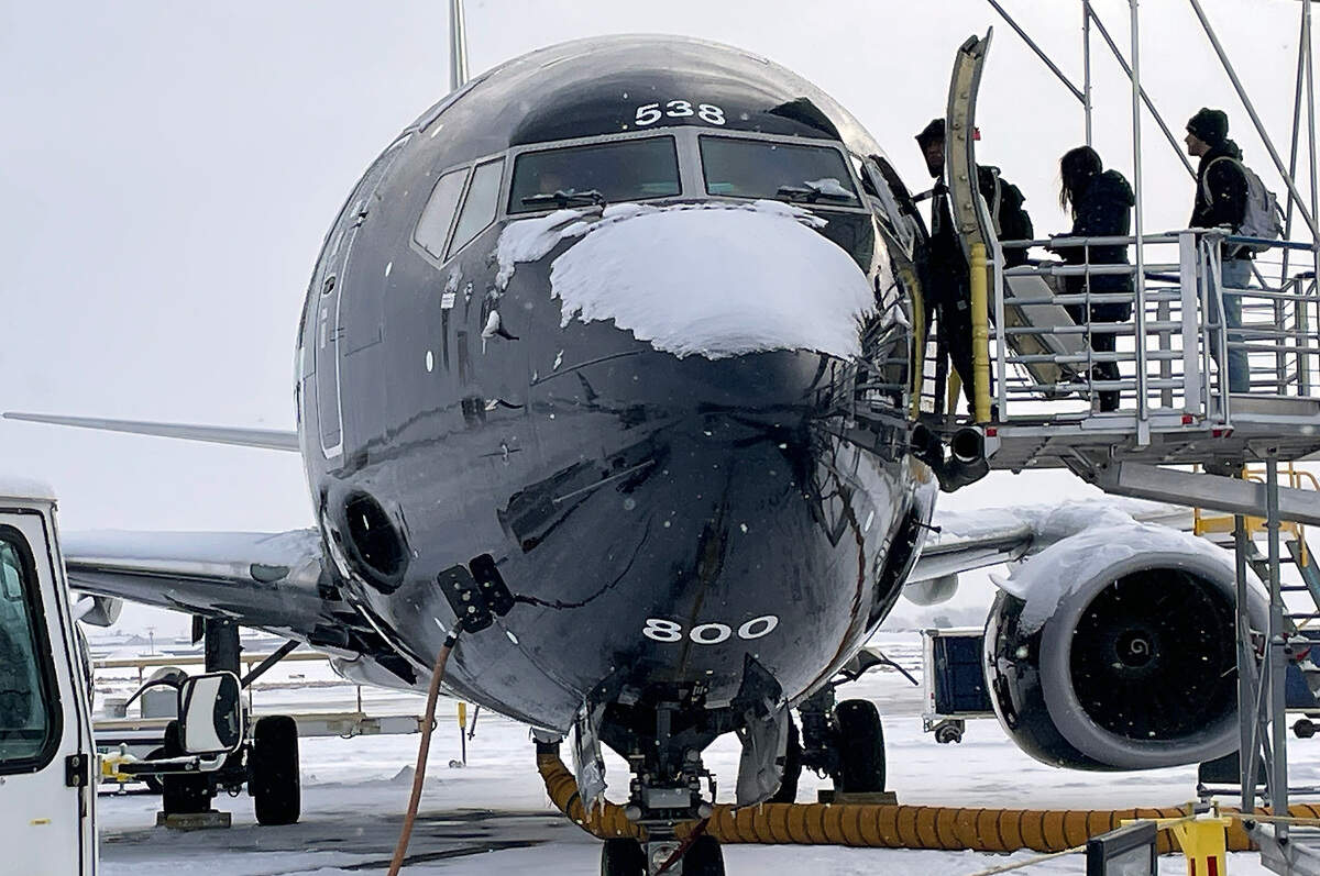 Passengers at the Tri-Cities Airport board a snow covered jet bound for Seattle Friday morning following a layer of fresh overnight snowfall that coated the Tri-Cities. The flight was delayed by about one hour.