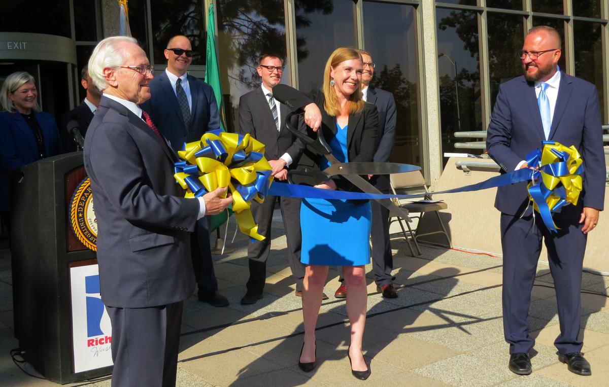 U.S. Senior Judge Edward F. Shea and 9th Circuit Court of Appeals Judge Salvador Mendoza help U.S. Attorney Vanessa Waldref cut the ribbon for a new federal office at the U.S. Courthouse in Richland.