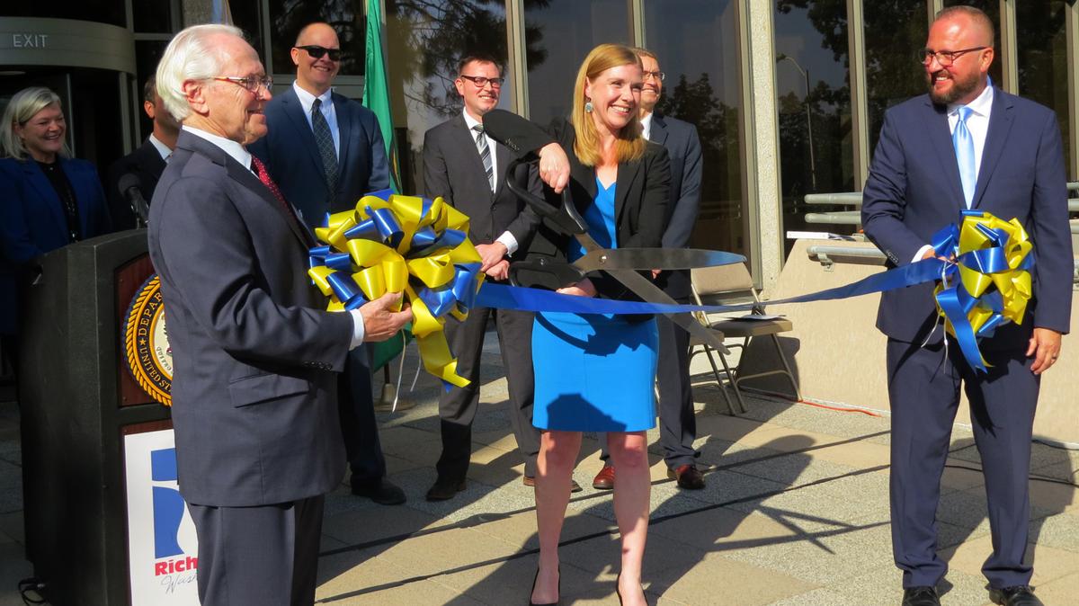 U.S. Senior Judge Edward F. Shea and 9th Circuit Court of Appeals Judge Salvador Mendoza help U.S. Attorney Vanessa Waldref cut the ribbon for a new federal office at the U.S. Courthouse in Richland.