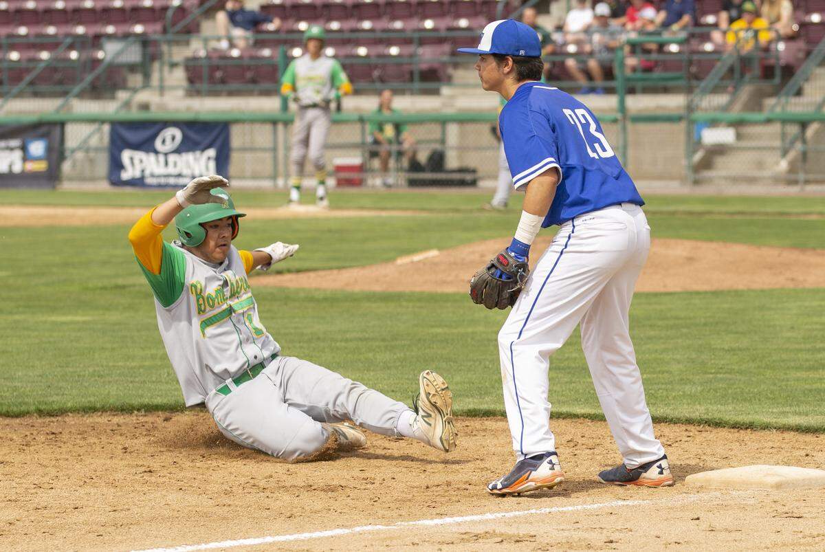 Richland’s Christian Berry slides into third base during a 4A baseball semifinal game against Federal Way on Friday at Gesa Stadium in Pasco.