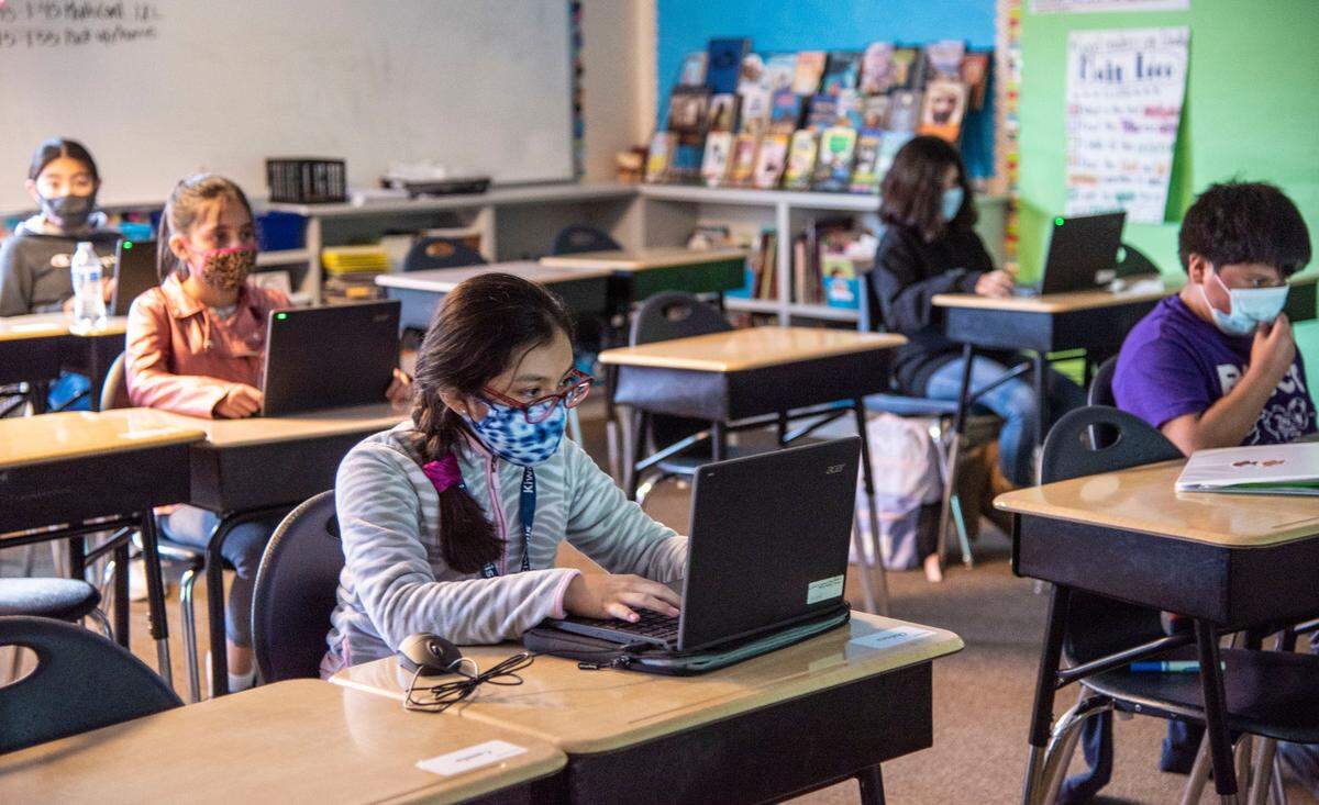 Students at Robert Frost Elementary participate in a computer activity during in March 2021.
