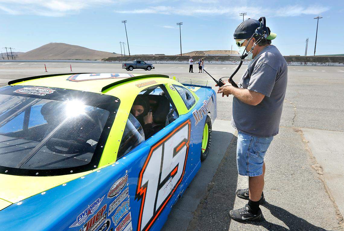 Crew member Rob Franklin checks his radio connection with his older brother, driver Jim Franklin, during the recent test day at the former Tri-City Raceway in West Richland.