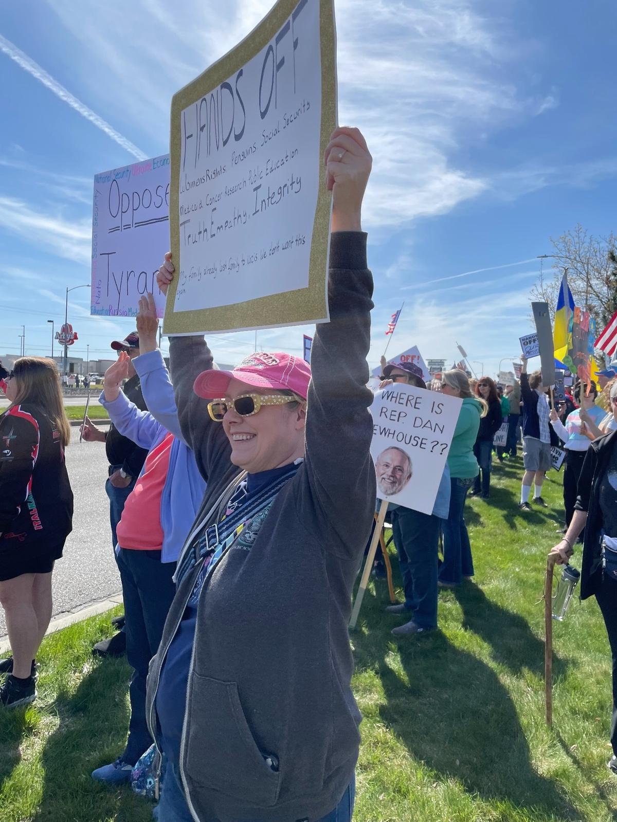 Hundreds of people lined Columbia Center Boulevard in Kennewick Saturday for a “Hands Off! Kennewick Fights Back,” to protest Trump administration policies.