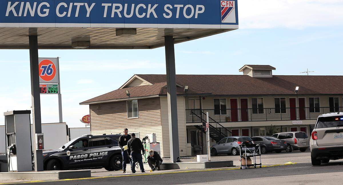 Pasco police investigators document the scene of Wednesday morning's fatal shooting near the gas pumps at King City Truck Stop off Highway 395 in Pasco. 