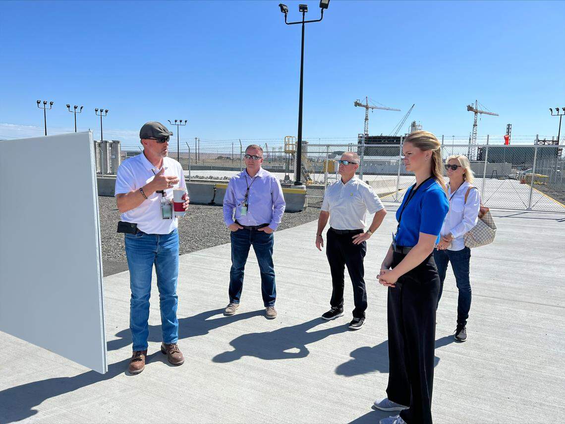 Ted Jarecki, left, of Washington River Protection Solutions, briefs Grace Stanke, Miss America 2023, in blue (right) at the Hanford tank farms where radioactive waste is being prepared to be immobilized in glass.