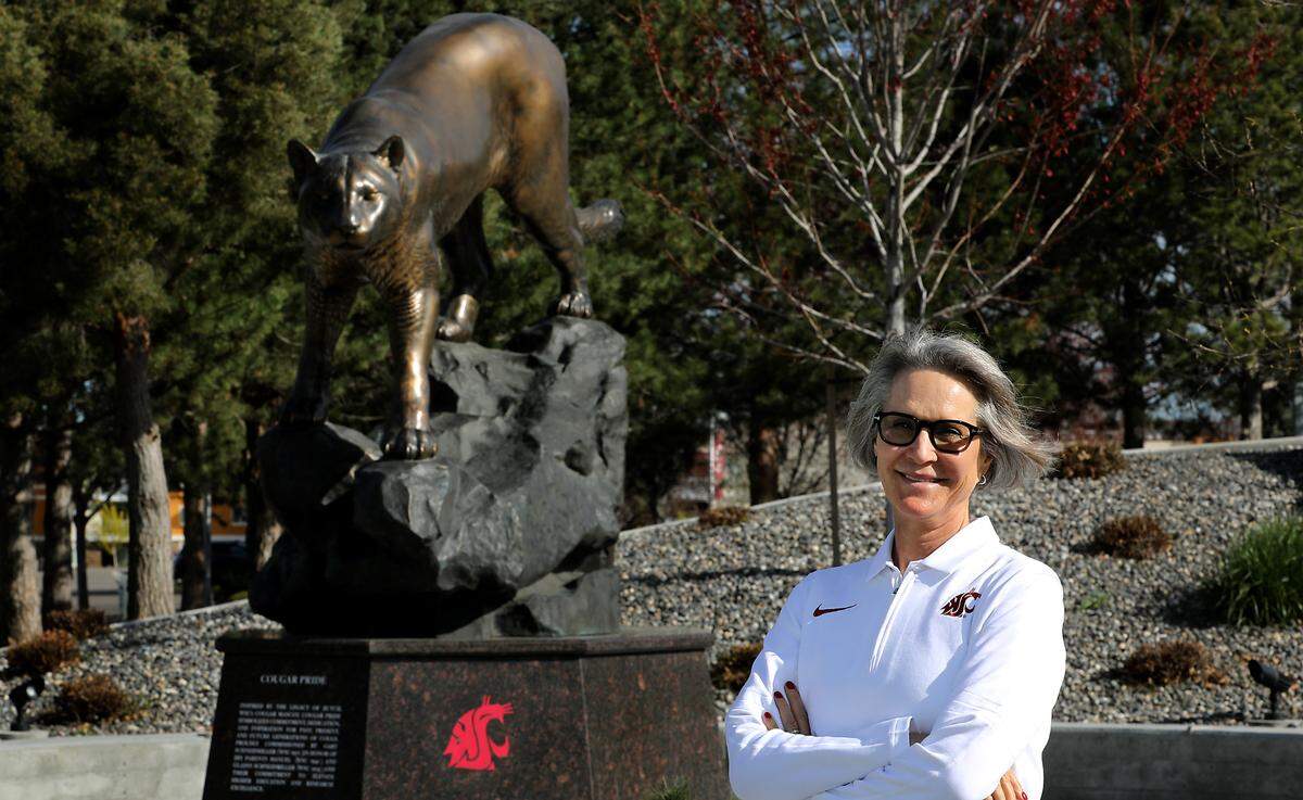 New WSU President Elizabeth Cantwell stands near the cougar statue at the WSU Tri-Cities campus in Richland during her first visit after being named to the post.